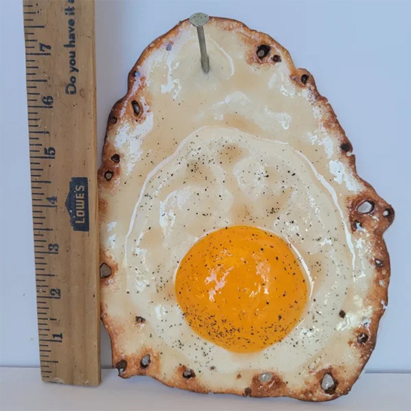 Fried Egg Hanging on a Nail